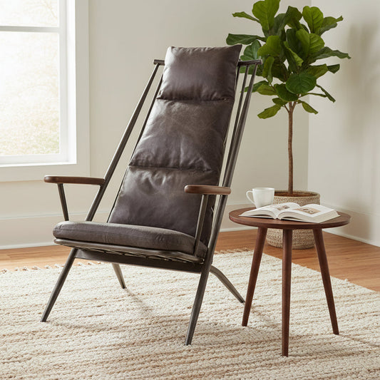 The Vintage Sofa Company Huntingdon Studio Chair features a black metal frame with a spindle reclined backrest, brown wooden arms and premium leather brown upholstered cushions