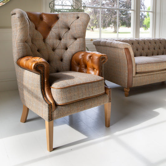 Vintage Sofa Company Kensington Deluxe Chair in Hunting Lodge Tweed with buttoned leather arms and wooden legs in a room setting