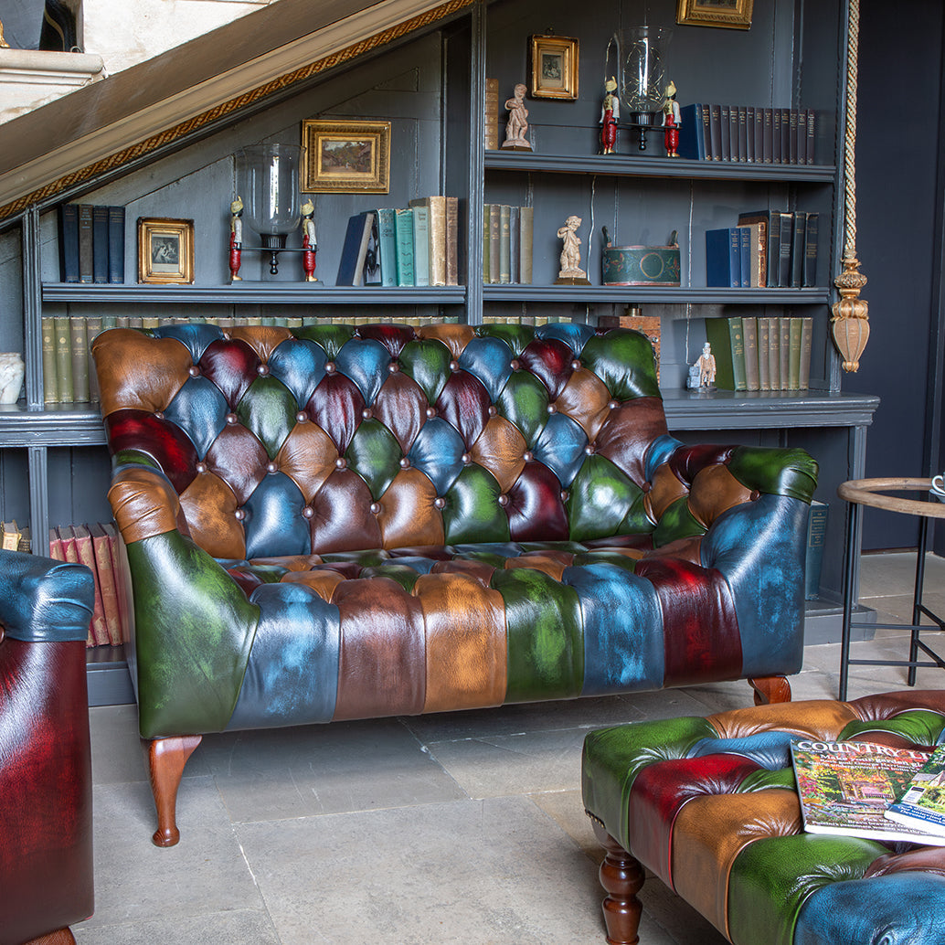 The Litton 2 Seater Sofa uses rub-off leather patchwork to create a bolder, more distinctive look than a standard leather sofa. Deep buttoning, rolled arms and a compact two-seater shape give it strong character, while the aged finish and rich colour variation make each piece feel individual.