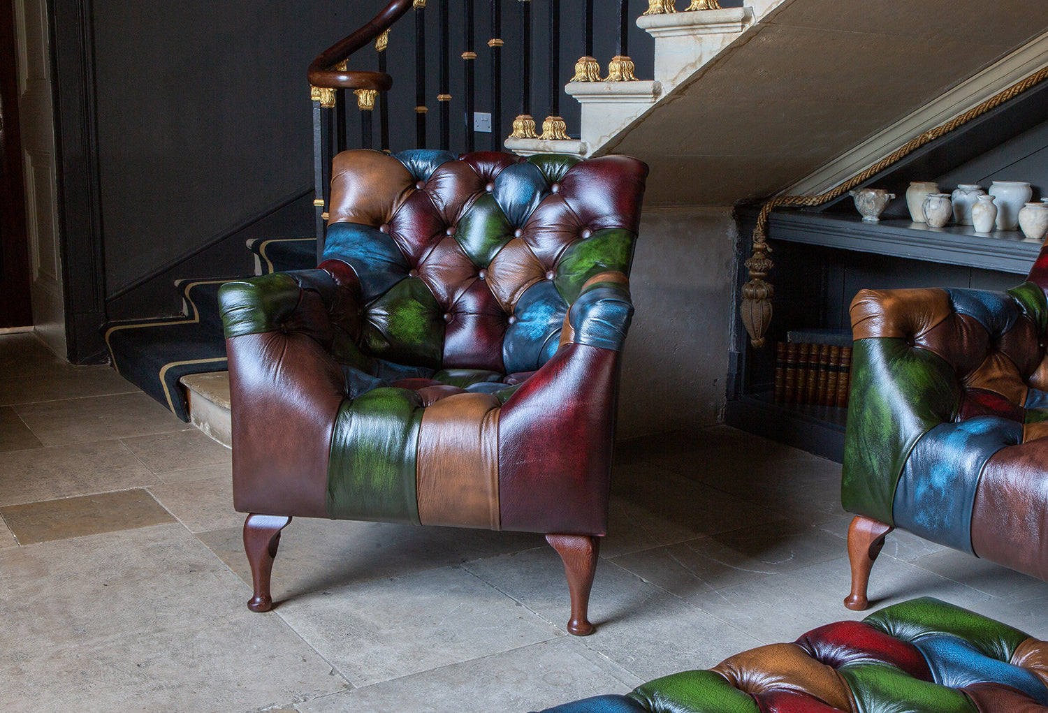 The Litton Armchair brings rub-off leather patchwork and deep buttoning together in a compact statement chair with real depth and character, from the Vintage Sofa Company Litton Collection