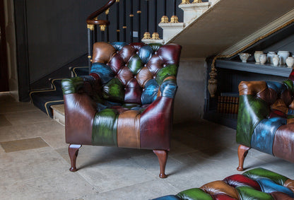 The Litton Armchair brings rub-off leather patchwork and deep buttoning together in a compact statement chair with real depth and character, from the Vintage Sofa Company Litton Collection