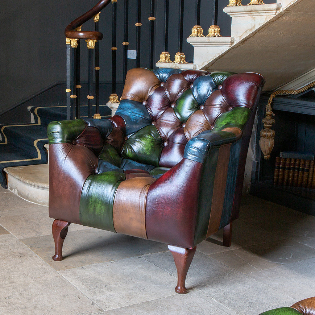 Vintage Sofa Company Litton Rub-Off Leather Patchwork Feature Armchair with curved seat, deep button tufting and dark wooden legs