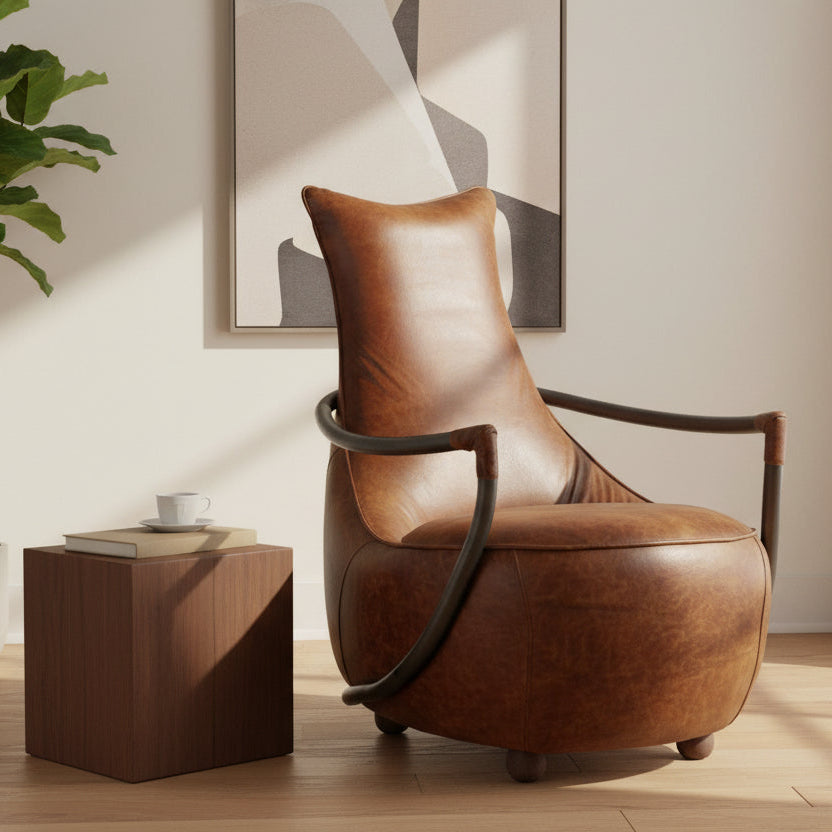 Vintage Sofa Company Maverick Retro Relax Chair upholstered in a tan brown leather with black metal arms and wooden ball feet