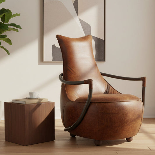 Vintage Sofa Company Maverick Retro Relax Chair upholstered in a tan brown leather with black metal arms and wooden ball feet