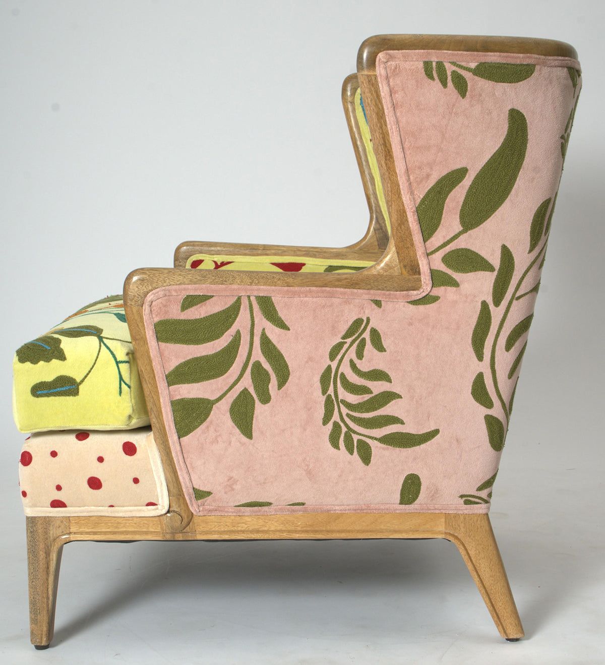 Vintage Sofa Company Morbi Chair features a mix of coloured fabrics and designs, from pinks, yellows and red polka dots, all within a solid wood frame with wingback design