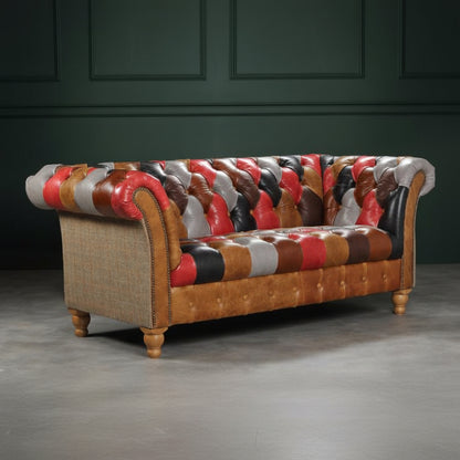 The Vintage Sofa Company Prestbury Patchwork 2 Seat Sofa is a multi coloured, Chesterfield inspired piece with classic diamond quilting design, rolled arms with stud detailing and turned wooden legs
