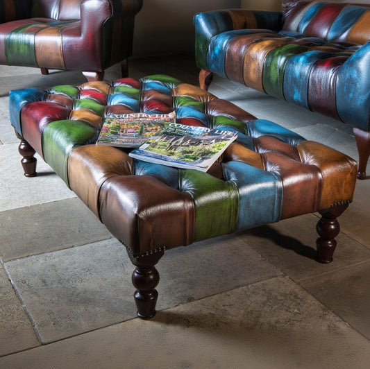 Vintage Sofa Company Rub Off Leather Patchwork Banquette Footstool with deep button tufted top, dark wooden legs and brass stud detailing