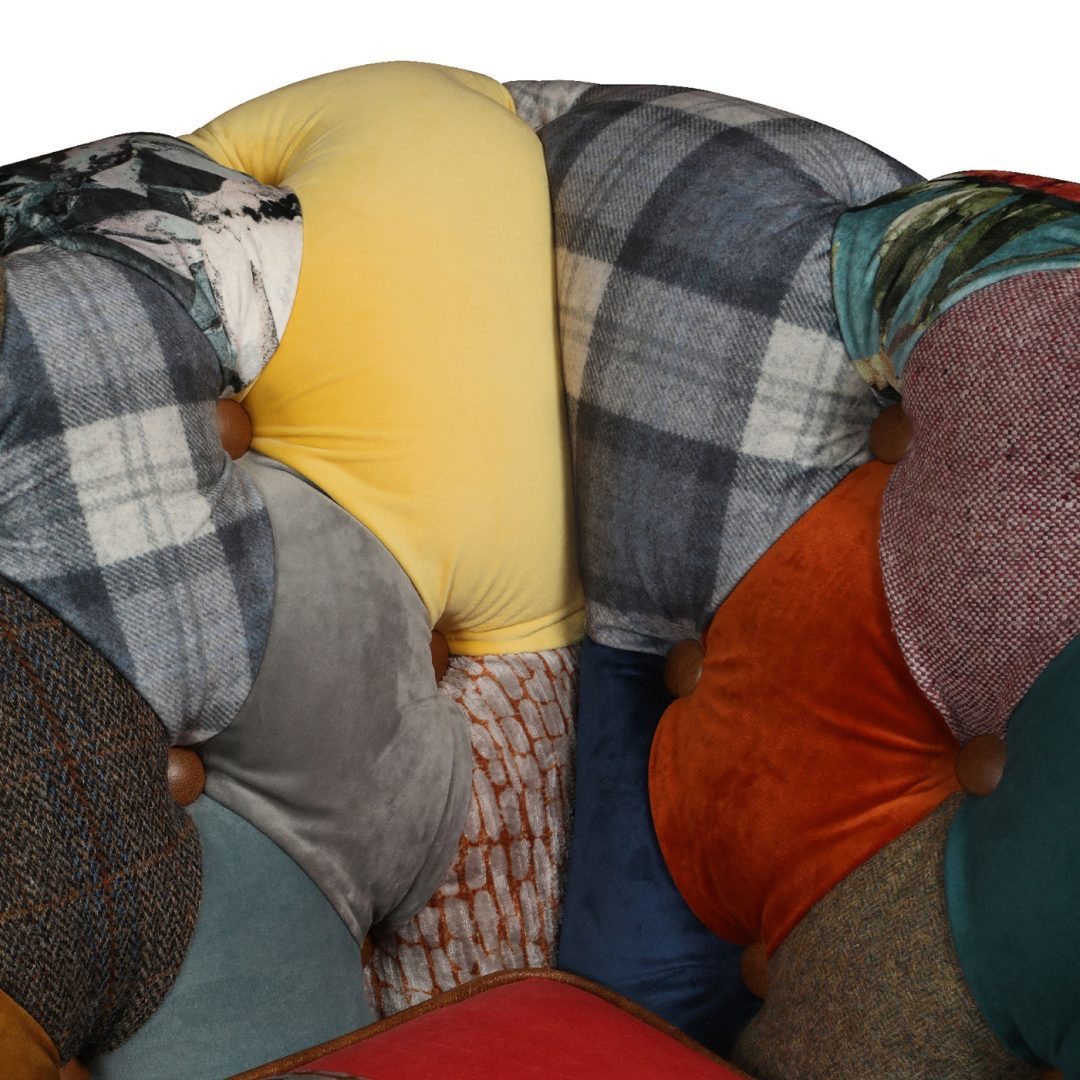 Vintage Sofa Company Rutland 3 Seater Sofa features deep tan leather button tufting to the classic Chesterfield diamond quilting featured across the back and arms of the sofa, and a mixture of materials are used to create the vibrant patchwork design