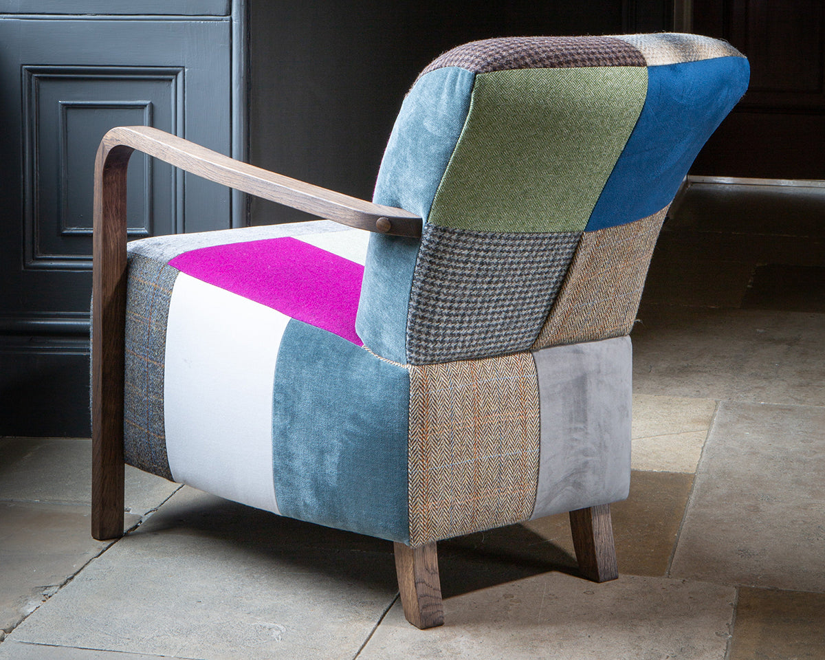Vintage Sofa Company Shaun Accent Chair with Antique Wooden Arms and legs, features a generous seat, upholstered in a mixed patchwork of tweeds, velvets, plain and checked fabrics
