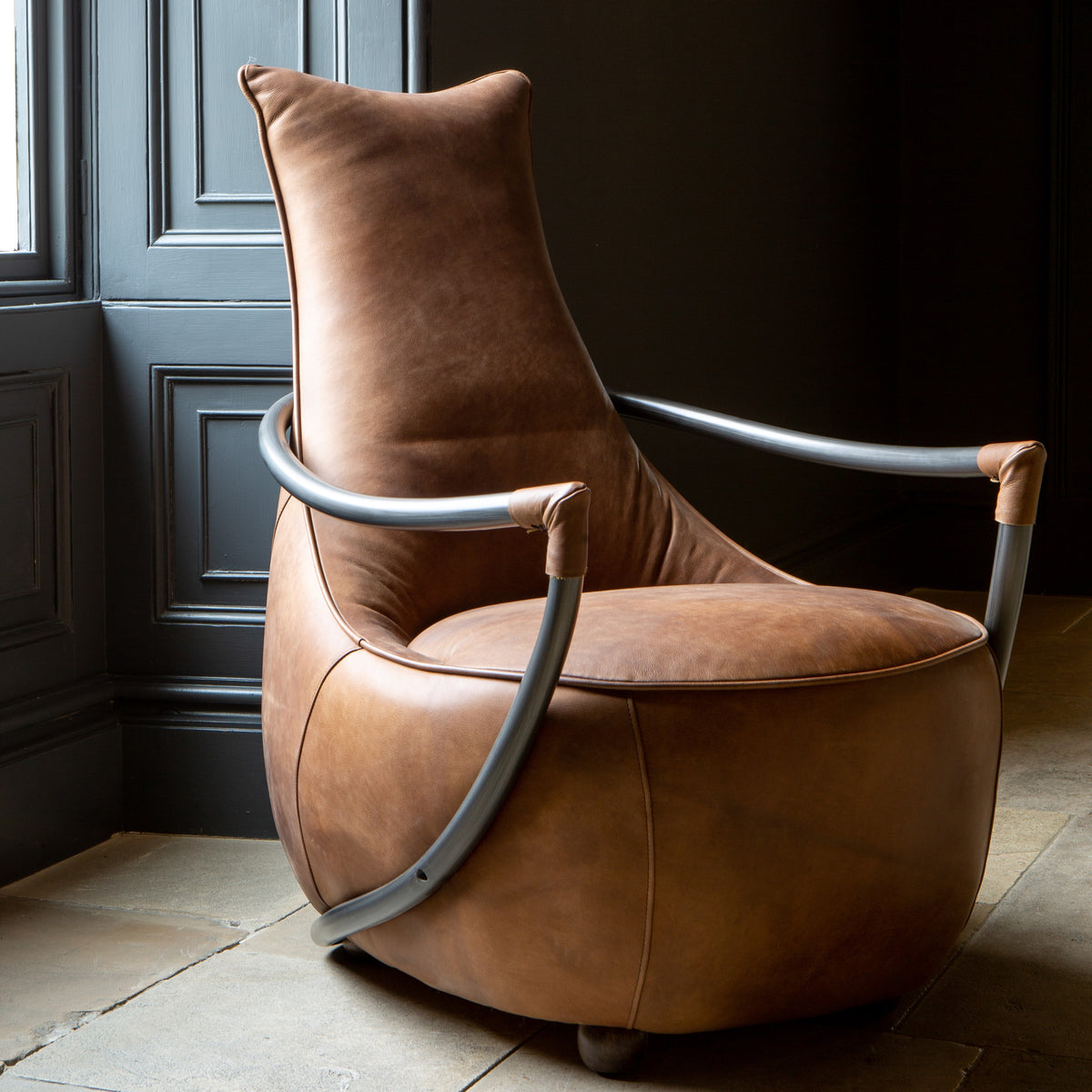 Carlton Furniture Maverick Retro Relax Armchair - angled room view of warm brown relax chair and curved frame