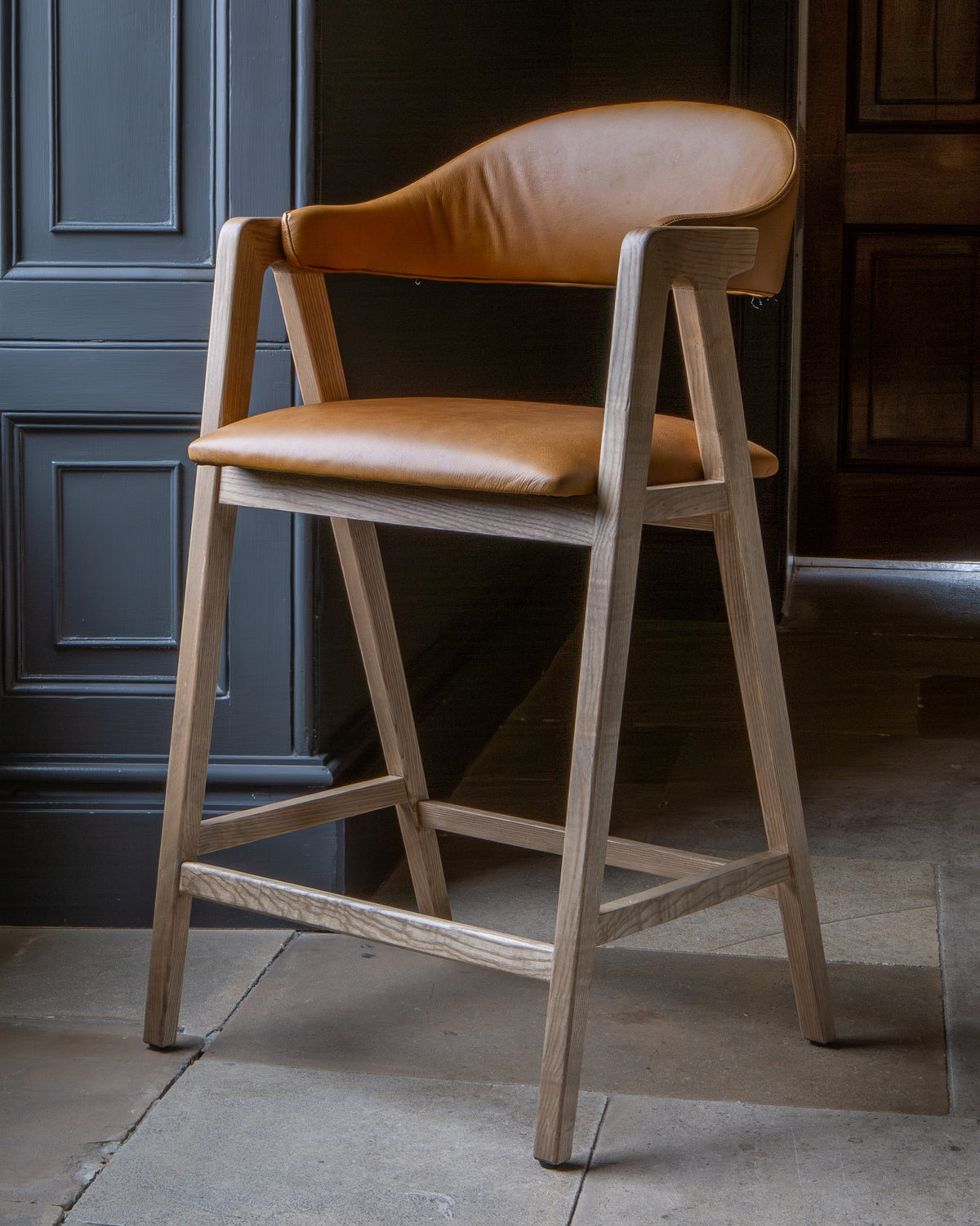 Carlton Furniture Ossby Barstool with Crossrail Tan Leather Grey Oiled Finish — lifestyle setting