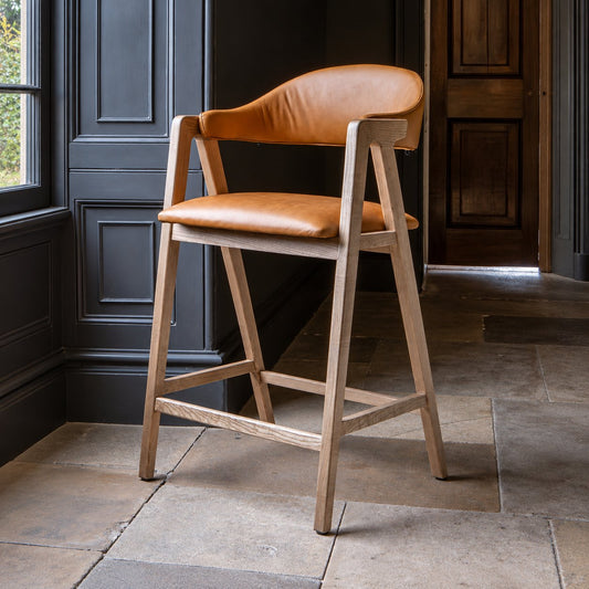 Carlton Furniture Ossby Barstool with Crossrail Tan Leather Grey Oiled Finish — lifestyle setting