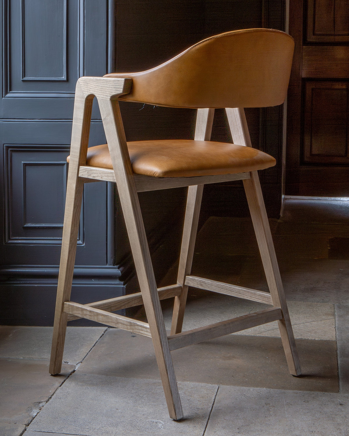 Carlton Furniture Ossby Barstool with Crossrail Tan Leather Grey Oiled Finish — lifestyle setting