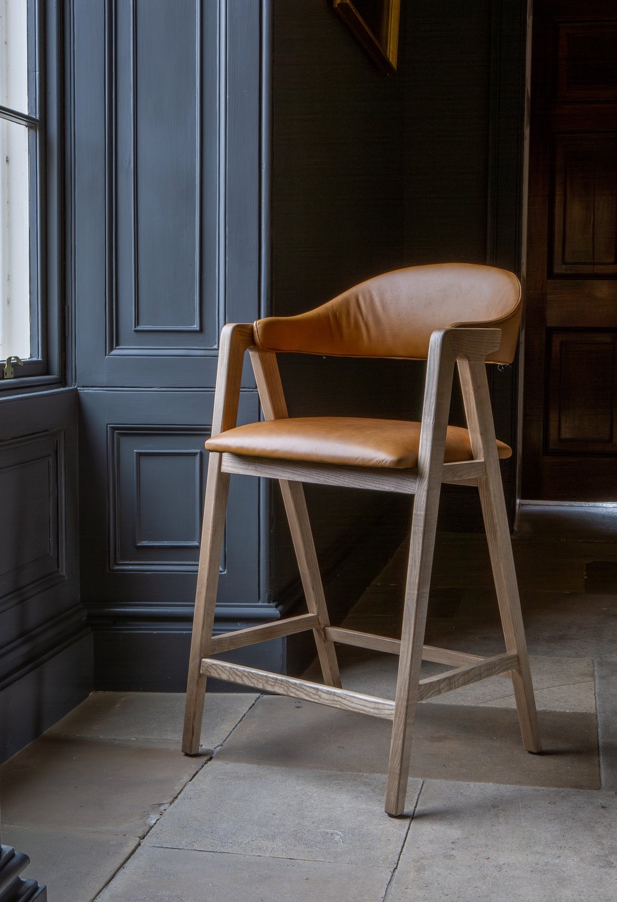 Carlton Furniture Ossby Barstool with Crossrail Tan Leather Grey Oiled Finish — lifestyle setting