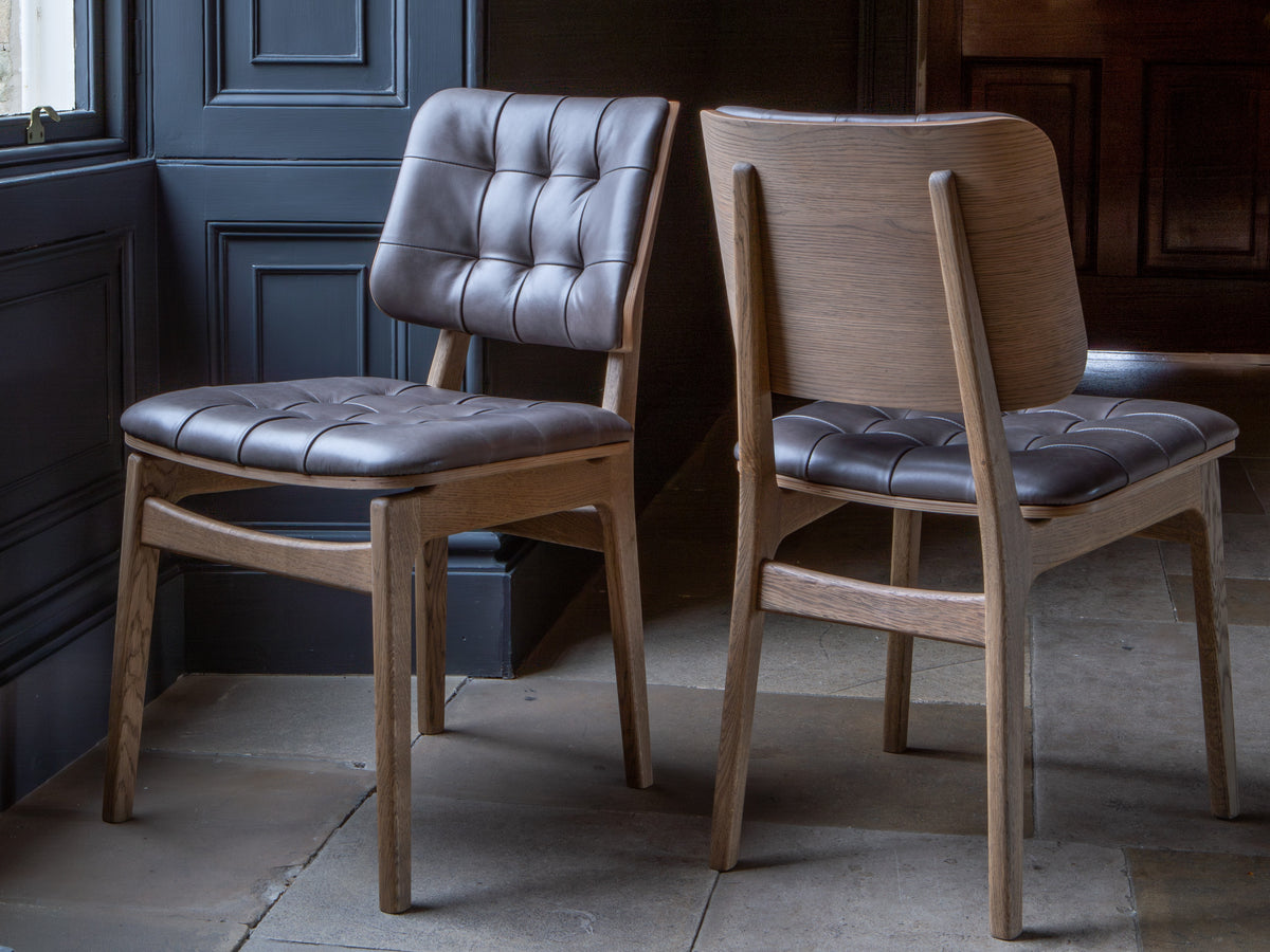 Carlton Furniture Pair of Boden Chairs upholstered seat and back in Grey Leather Grey oil legs — lifestyle setting