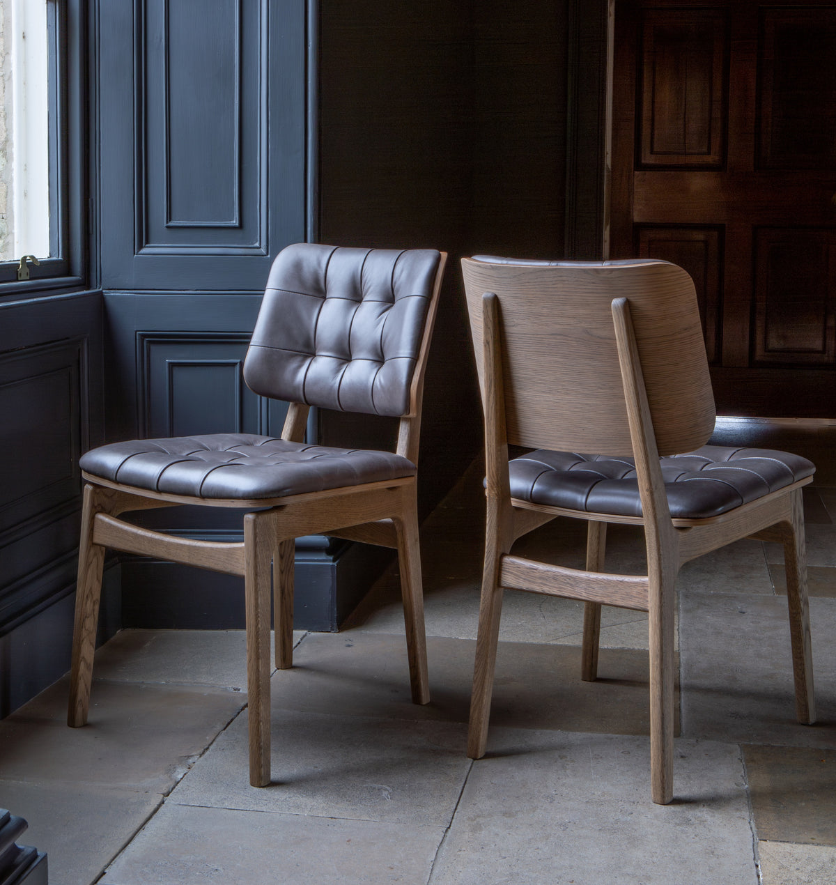 Carlton Furniture Pair of Boden Chairs upholstered seat and back in Grey Leather Grey oil legs — lifestyle setting