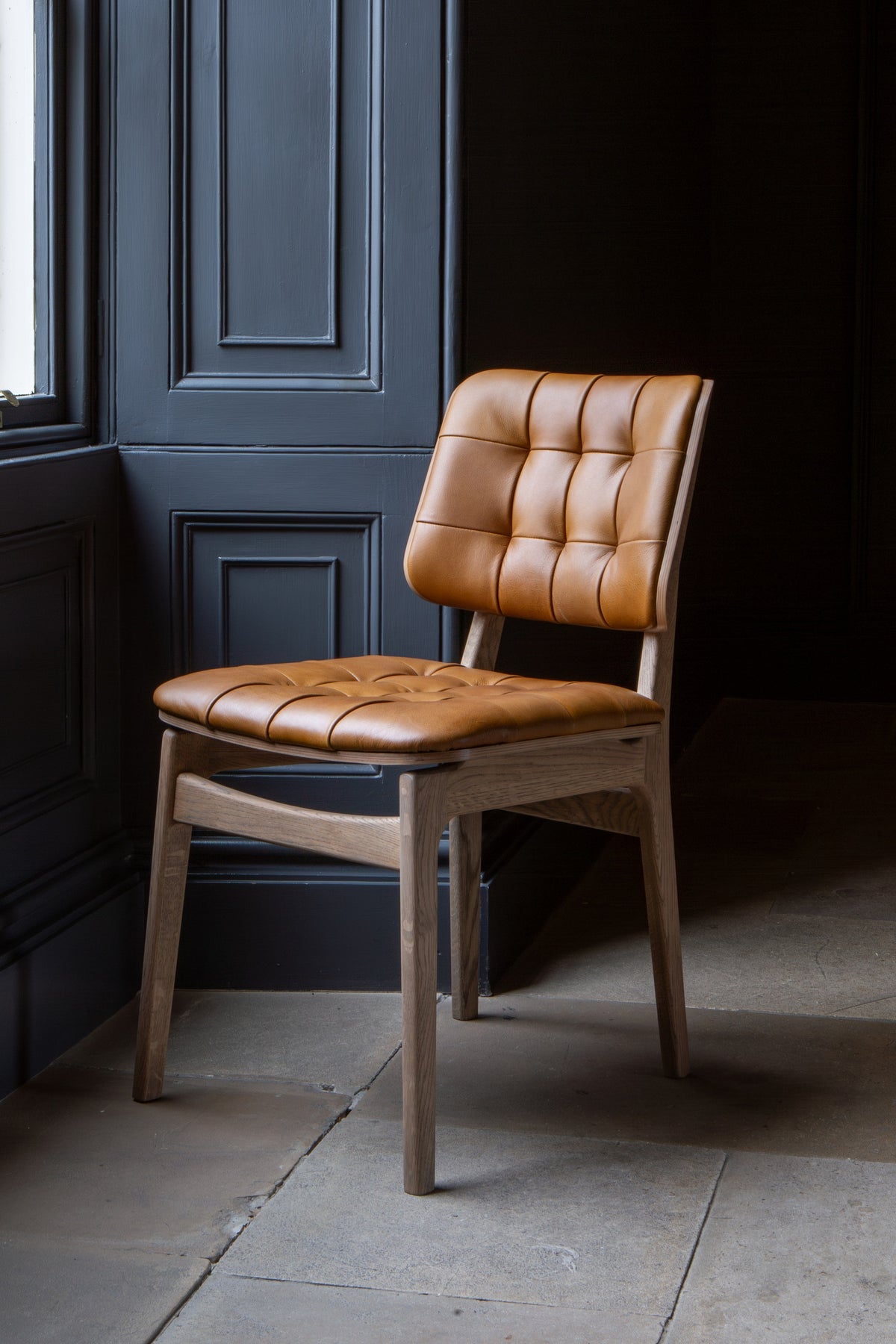 Carlton Furniture Pair of Boden Chairs upholstered seat and back in Tan Leather Grey oil legs — lifestyle setting