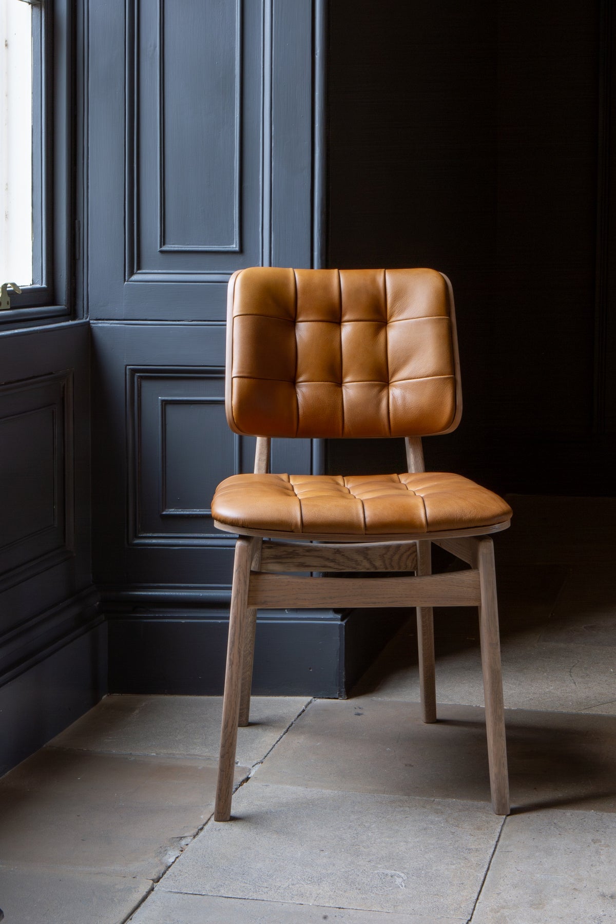 Carlton Furniture Pair of Boden Chairs upholstered seat and back in Tan Leather Grey oil legs — lifestyle setting