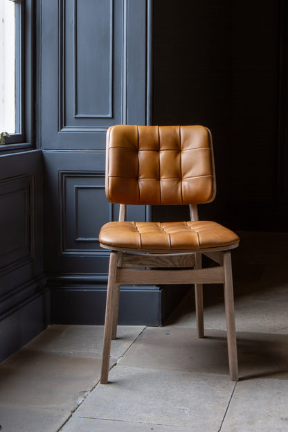 Carlton Furniture Pair of Boden Chairs upholstered seat and back in Tan Leather Grey oil legs — lifestyle setting