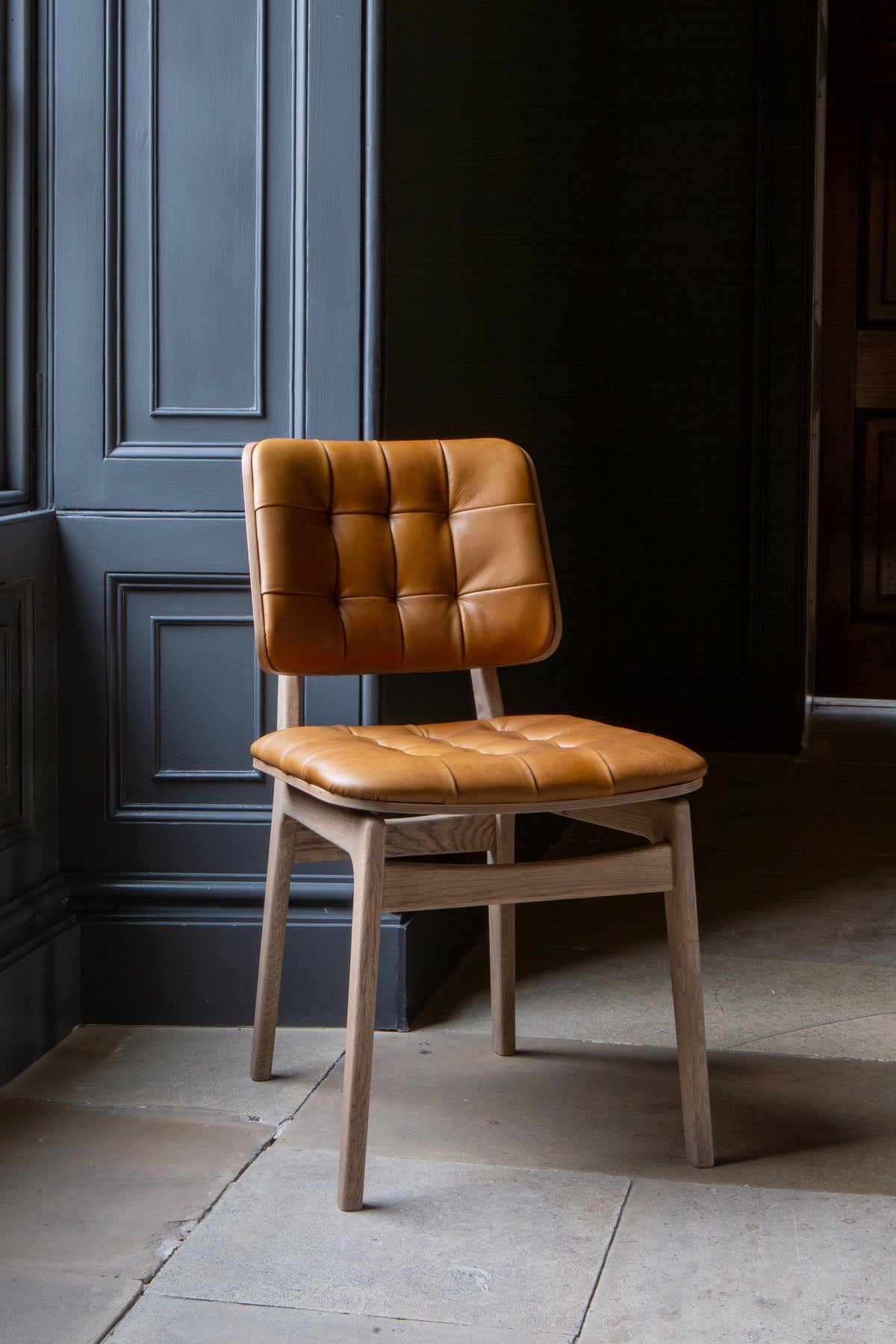 Carlton Furniture Pair of Boden Chairs upholstered seat and back in Tan Leather Grey oil legs — lifestyle setting