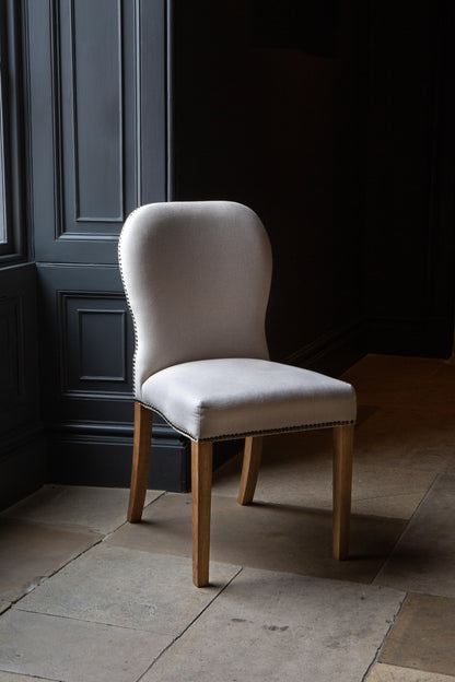 Carlton Furniture Pair of Pavilion Dining Chairs - Natural Linen Grey oil legs & Brass Studs — lifestyle setting