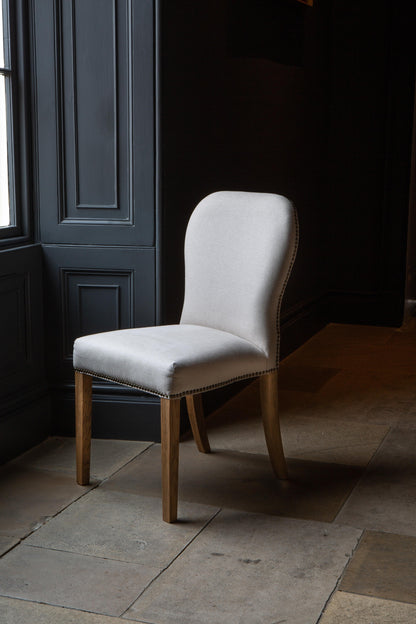 Carlton Furniture Pair of Pavilion Dining Chairs - Natural Linen Grey oil legs & Brass Studs — lifestyle setting