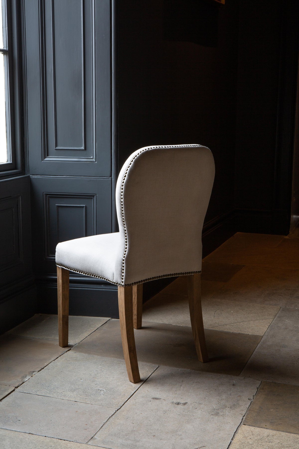 Carlton Furniture Pair of Pavilion Dining Chairs - Natural Linen Grey oil legs & Brass Studs — lifestyle setting