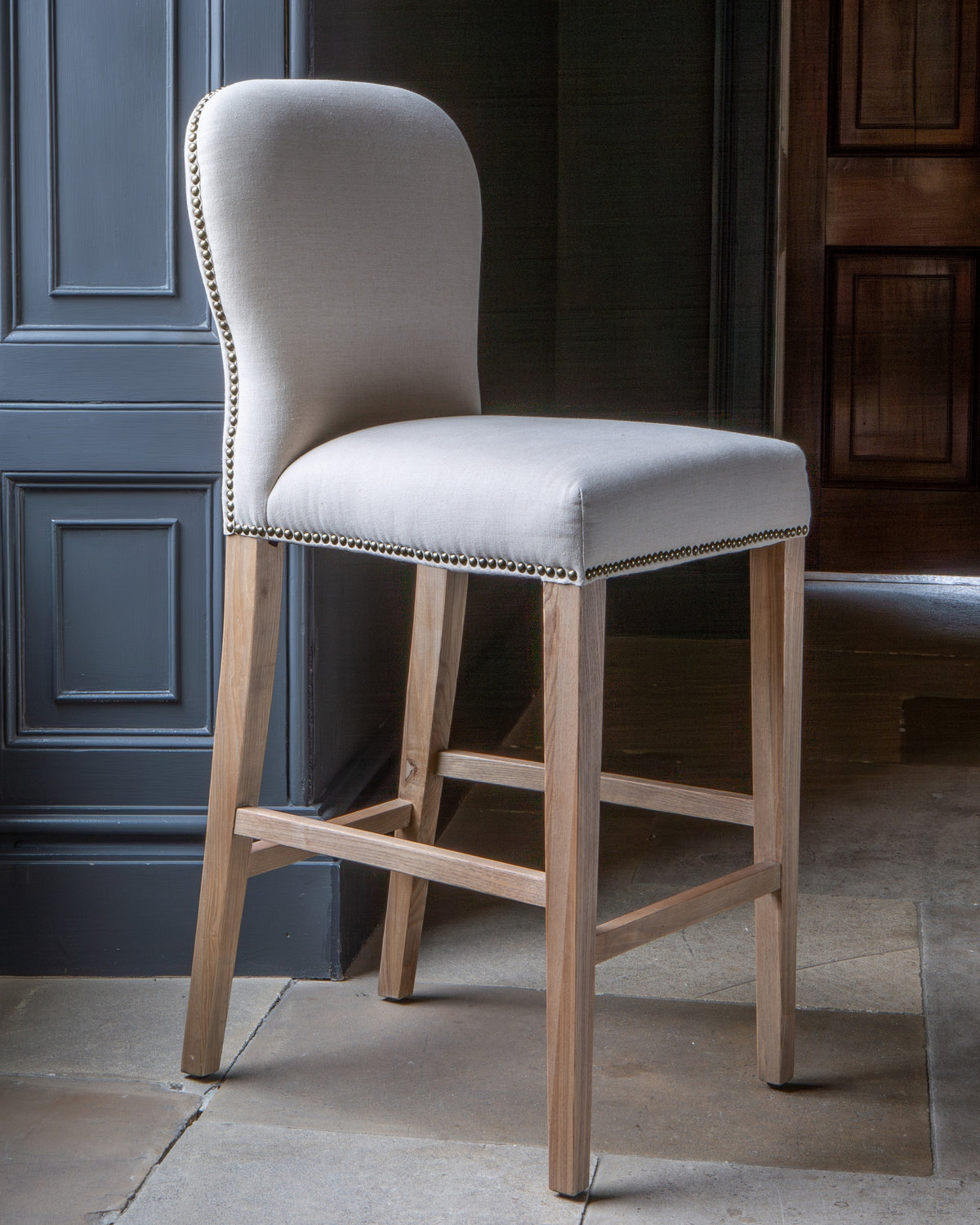 Carlton Furniture Pavilion Barstool - Natural Linen Grey oil legs & Brass Studs — lifestyle setting