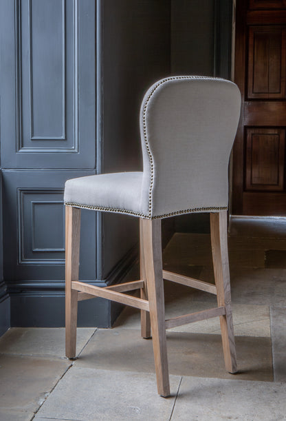 Carlton Furniture Pavilion Barstool - Natural Linen Grey oil legs & Brass Studs — lifestyle setting