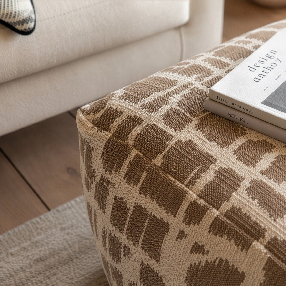 Gallery Direct Elara Jacquard Pouffe Mocha 550x550x350mm - jacquard upholstery detail beside a sofa