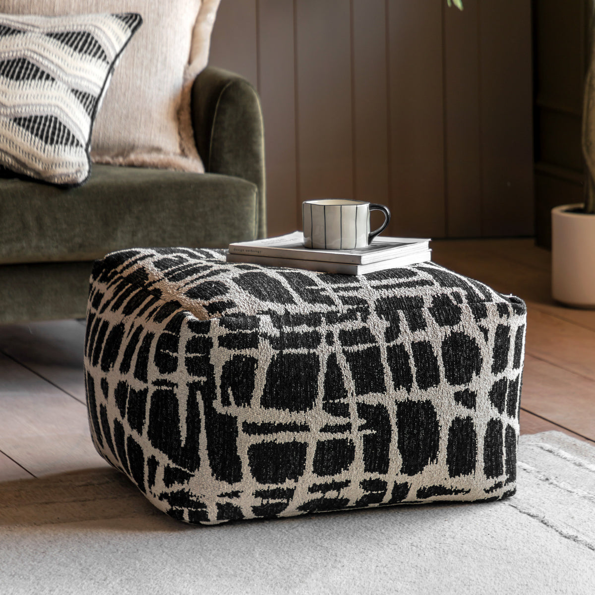 Gallery Direct Elara Jacquard Pouffe Slate 550x550x350mm - styled beside a sofa