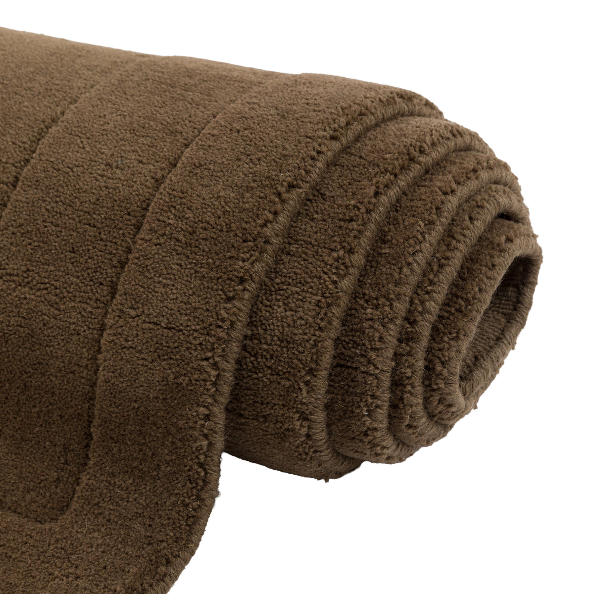 Gallery Direct Sienna Rug Chocolate - rolled rug showing weave and pile texture