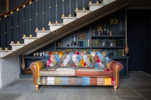 Dickinson 2 Seat Large Sofa In Patchwork  Tan Leather With Mid Oak Legs | Shackletons